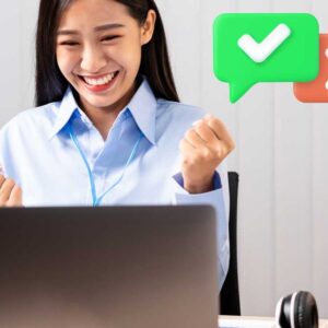 Author reacting happily to feedback from her computer, representing an acception vs. rejection concept